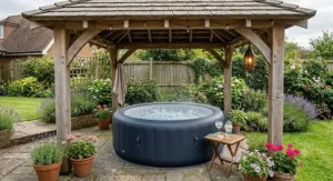 A stylish 2 person inflatable hot tub positioned inside a sheltered wooden garden gazebo.