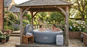 Couple unwinding in an affordable inflatable spa sheltered beneath a wooden garden gazebo