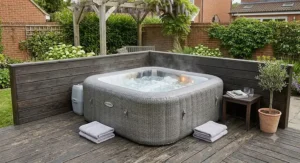 Space-saving square inflatable spa neatly positioned in the corner of a wooden decking area