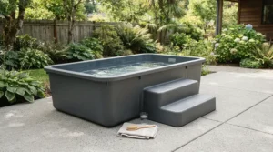 A seamless one-piece rotomoulded hot tub featuring an integrated entry step on a modern patio.