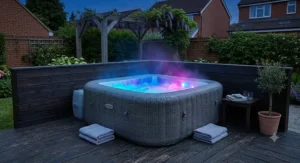 Square inflatable hot tub with vibrant underwater LED lights illuminated during a British evening